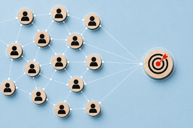 A network of connected people icons converging on a bullseye target, illustrating focused audience targeting